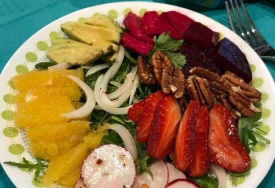 Strawberry and orange salad on mixed greens