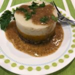 Image of stuffing, squash and mashed potatoes pressed into a ring mold and topped with gravy and parsley.ing