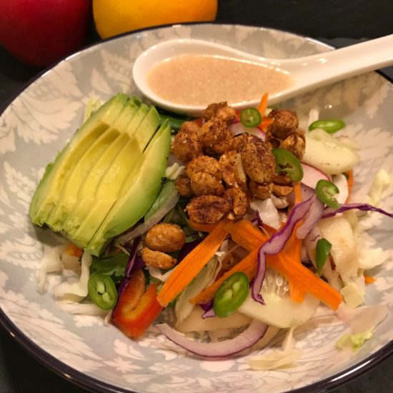 Image of a green salad with Chili peanuts and avocado