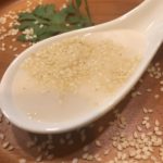 Image of a creamy white salad dressing with sesame seeds