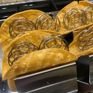 Image of taco shells in metal holders with steel balls inserted