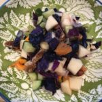 Image of a waldorf salad with blue cabbage, butternut squash and cranberries