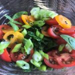 Image of Spinach with sliced tomatoes and green onion