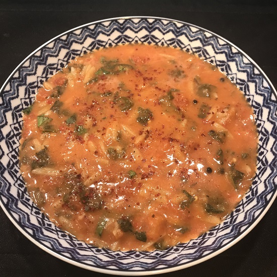 Image of tomato soup with spinach and orzo pasta