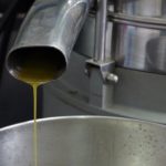 Image of a pipe with olive oil dripping from it