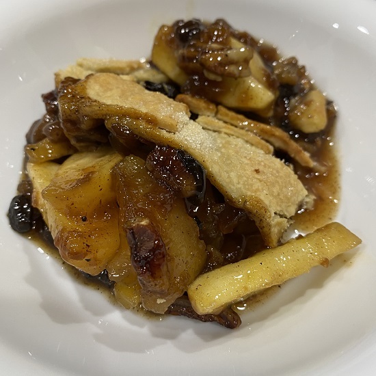 Image of a serving of mince meat, apple and pecan pie