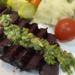 Image of beet steaks with chimichurri topping